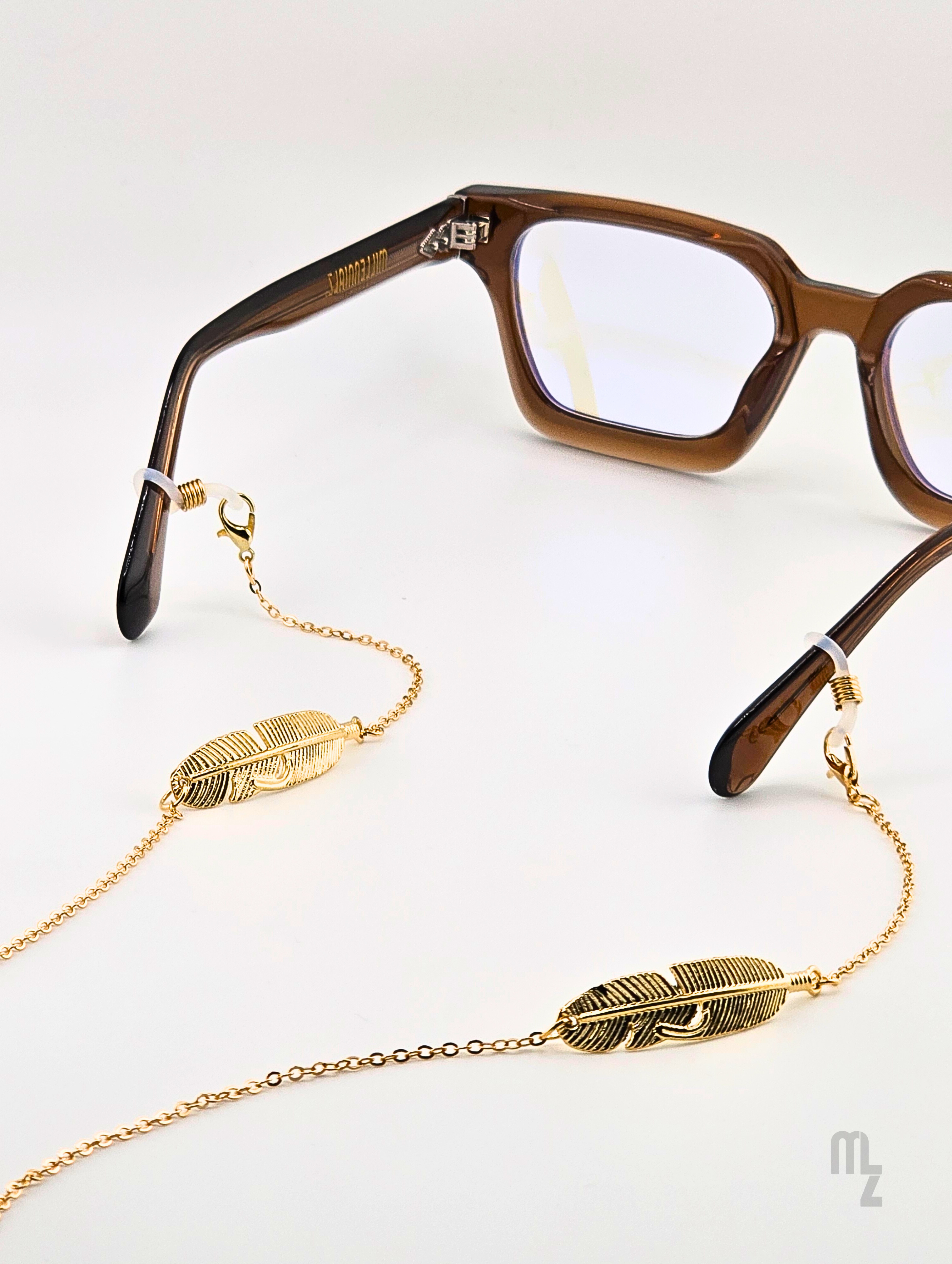Feather Luxe – Brillenkette aus goldfarbenen Edelstahlfedern im High-End-Look.